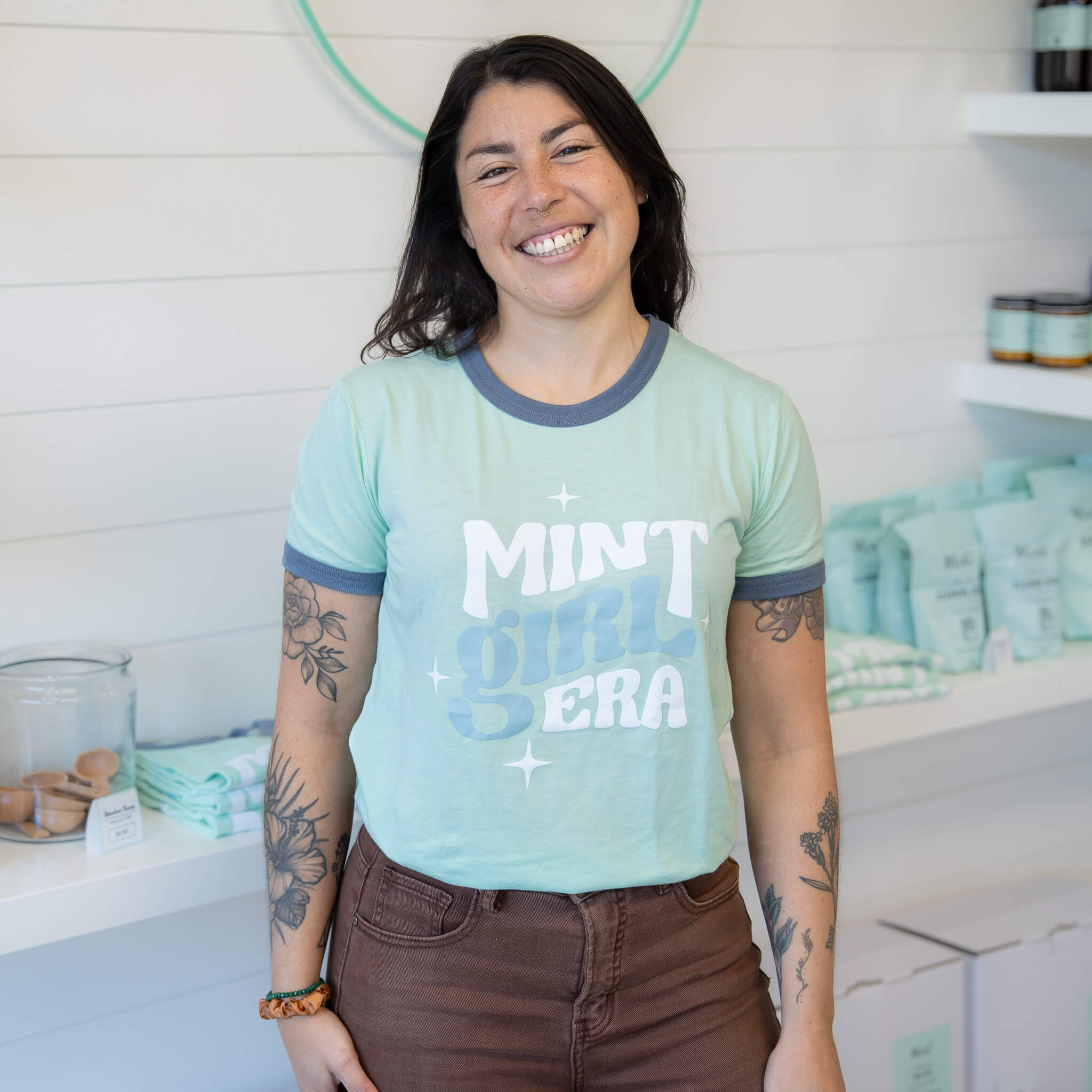 Person wearing a light blue t-shirt with &