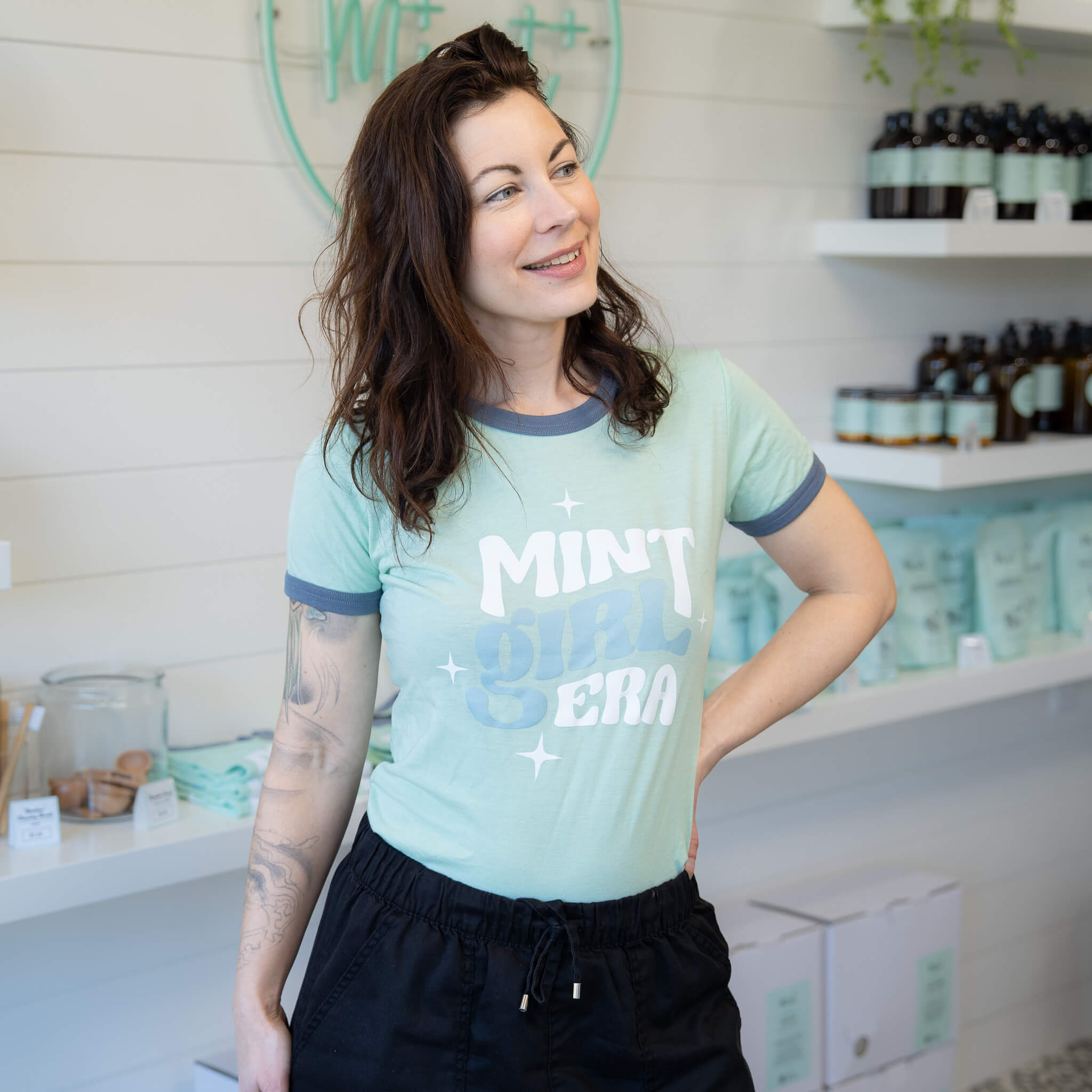 Woman wearing a light blue t-shirt with &