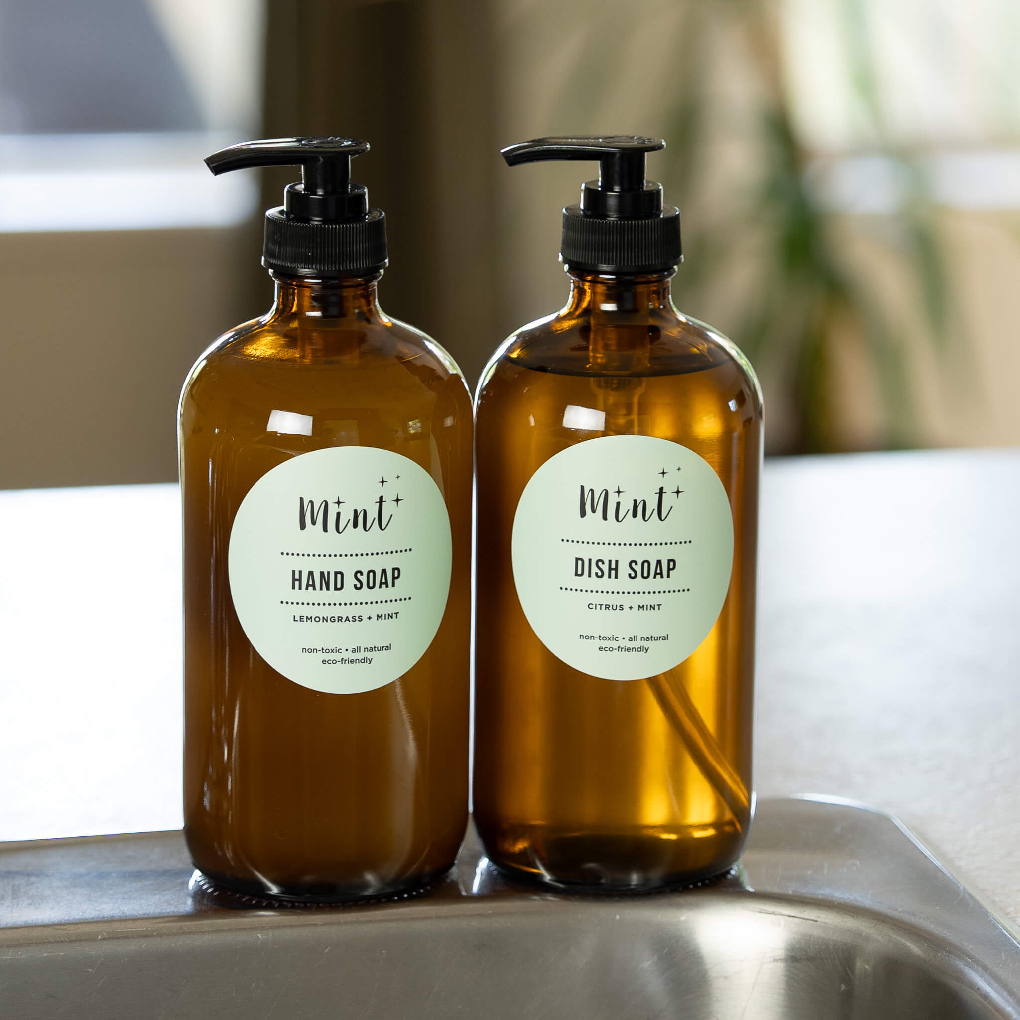 Mint Hand Soap and Dish Soap in amber glass bottles, displayed in the kitchen.