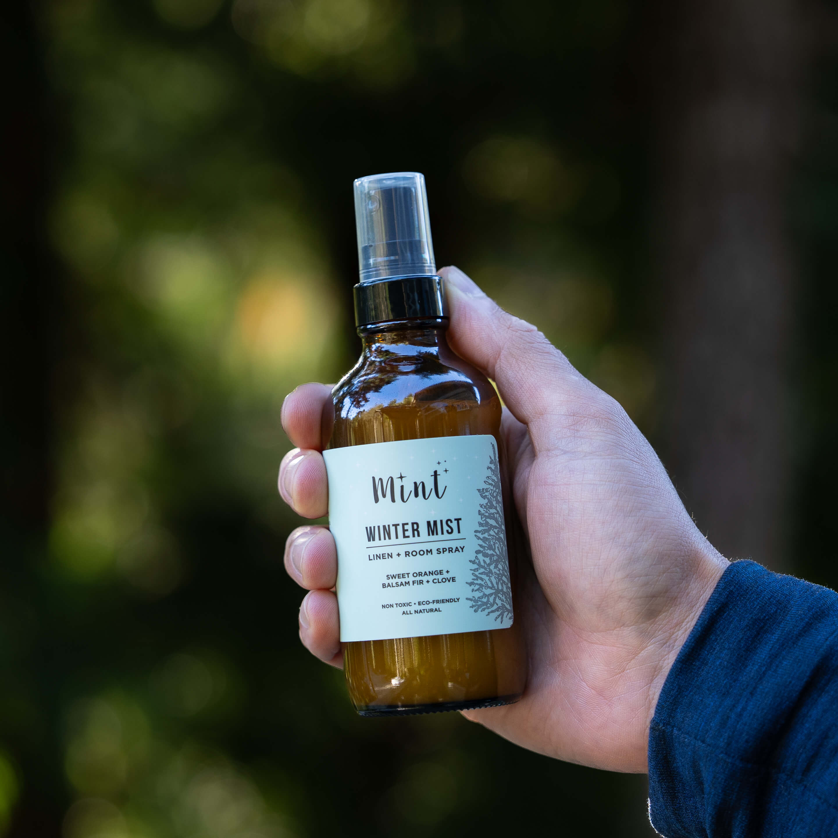 Hand holding a bottle of &