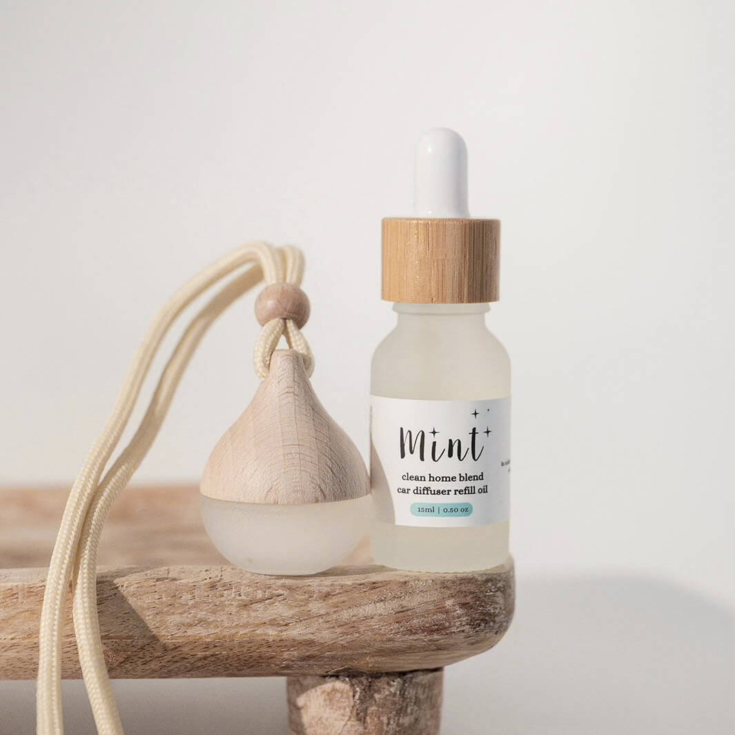 Bottle of Mint essential oil with a dropper on a wooden surface