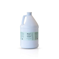 A 3.8-liter jug of Mint Cleaning Products' Lavender Mint Conditioner. The white jug has a light coloured label adorned with botanical sketches and text detailing the product's features. Presented on a clean white background with a faint reflection.