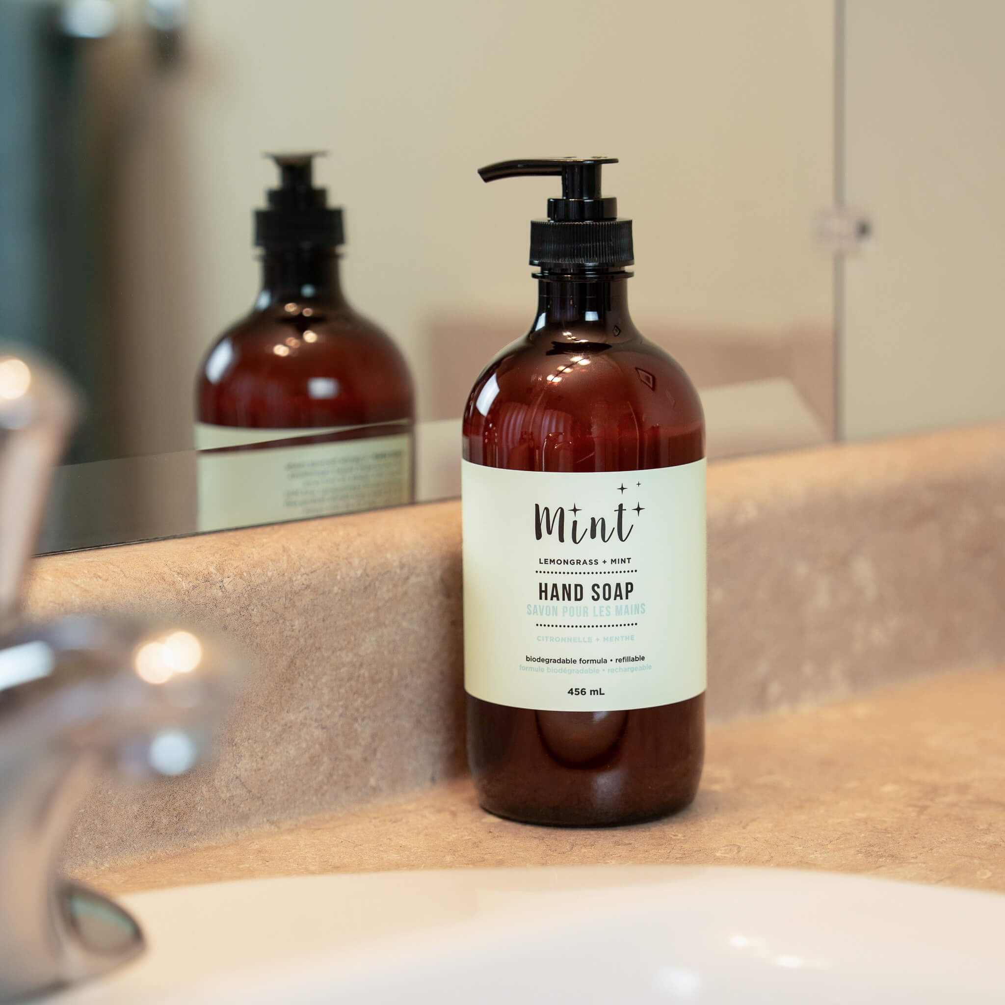 Brown hand soap bottle with a label on a bathroom counter