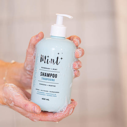 Close-up of hands holding a bottle of Mint Cleaning Products&