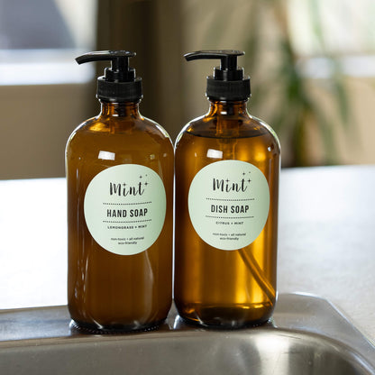 Mint Hand Soap and Dish Soap in amber glass bottles, displayed in the kitchen.