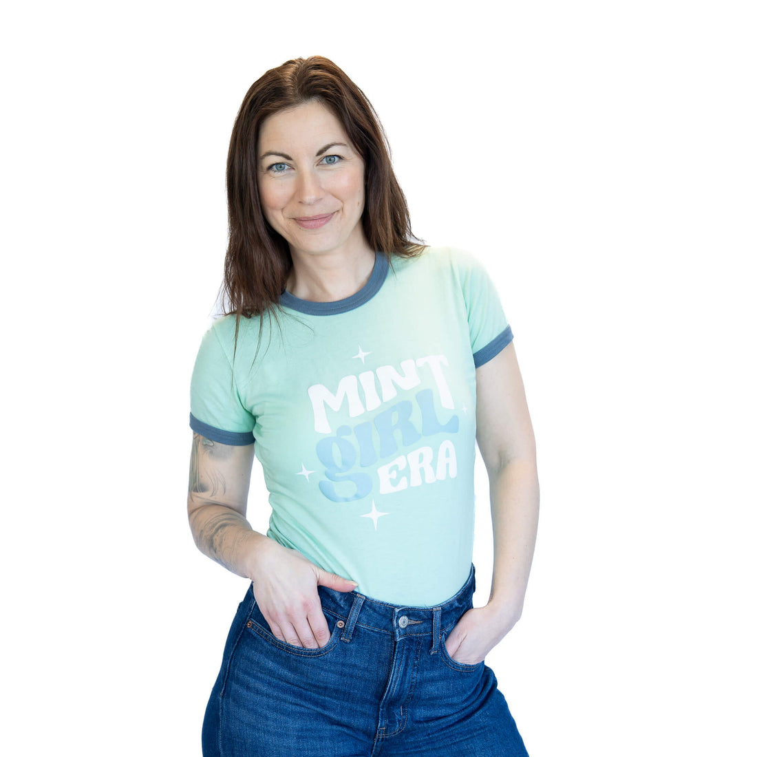 Woman wearing a light green t-shirt with text on a white background