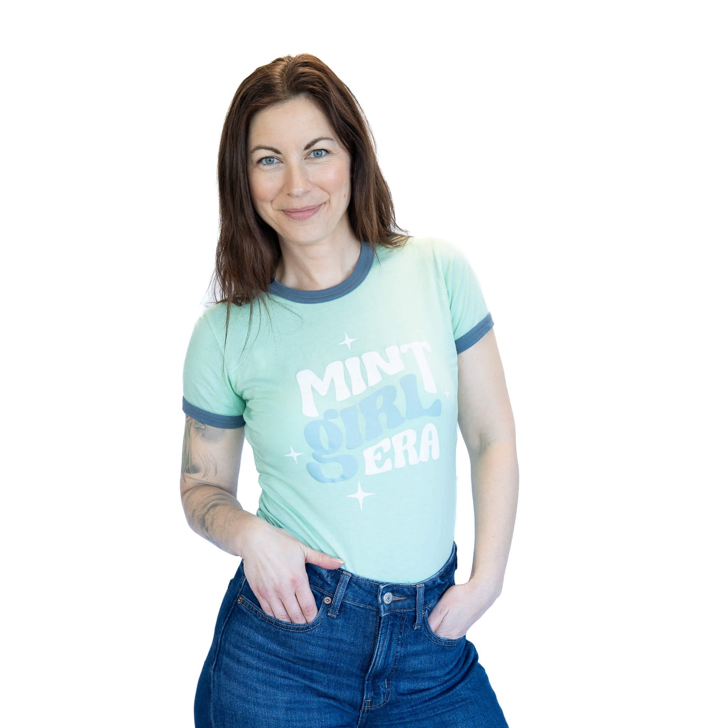 Woman wearing a light green t-shirt with text on a white background
