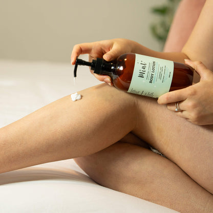 Person applying lotion from a bottle labeled &