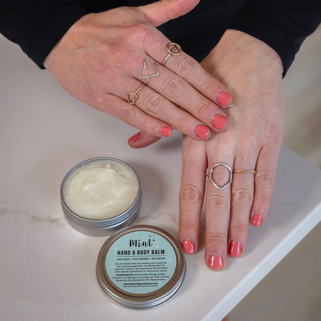 Close-up of hands applying Mint Hand & Body Balm, showing the balm&