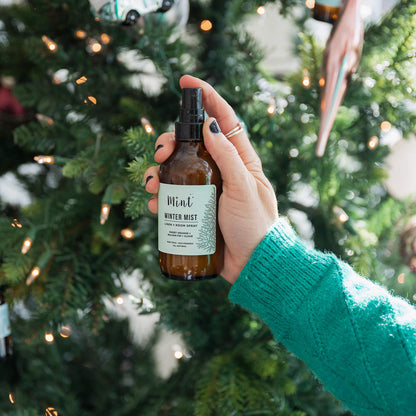 Hand holding a bottle labeled &