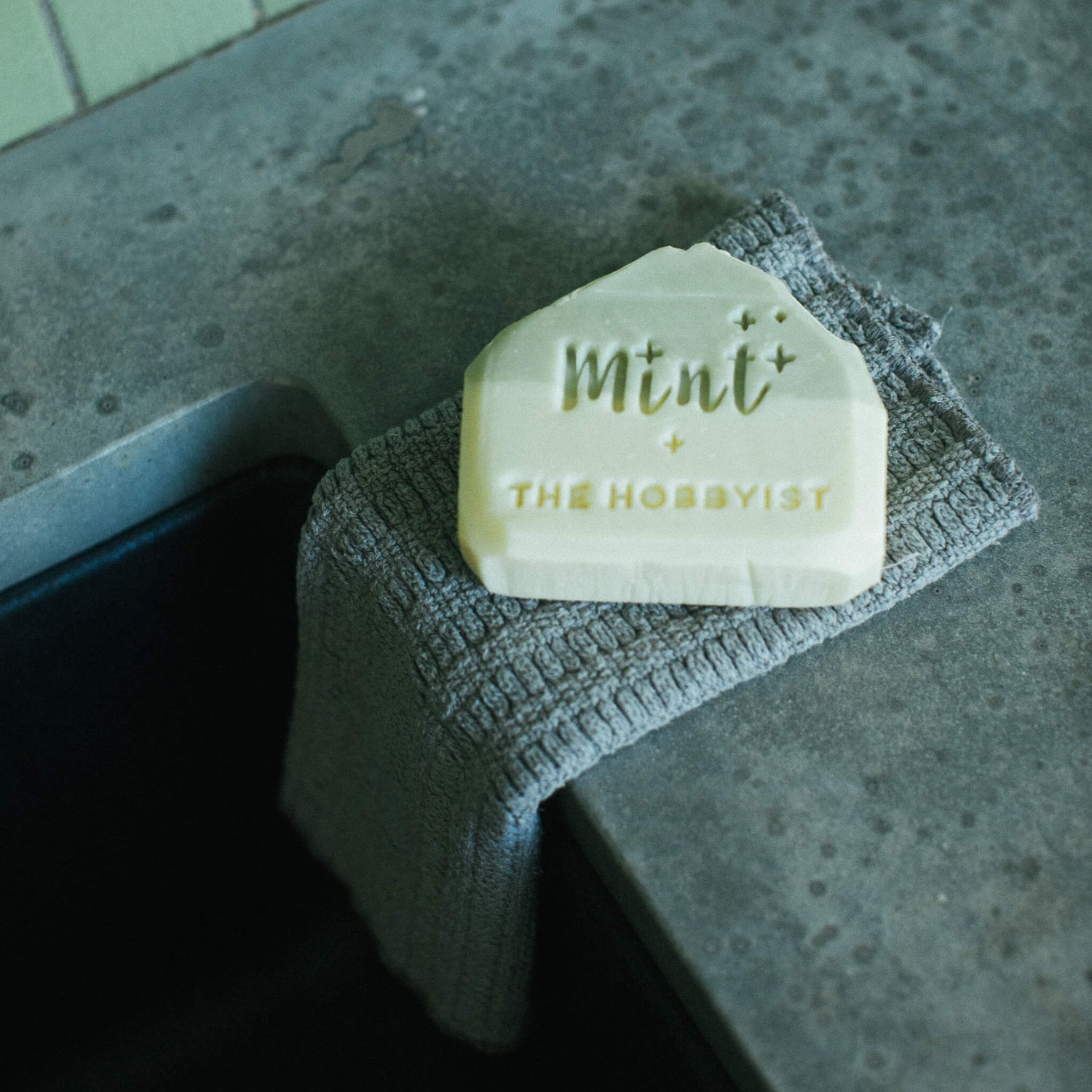 Mint and Tofino Hobbiest Botanical soap on counter with towel