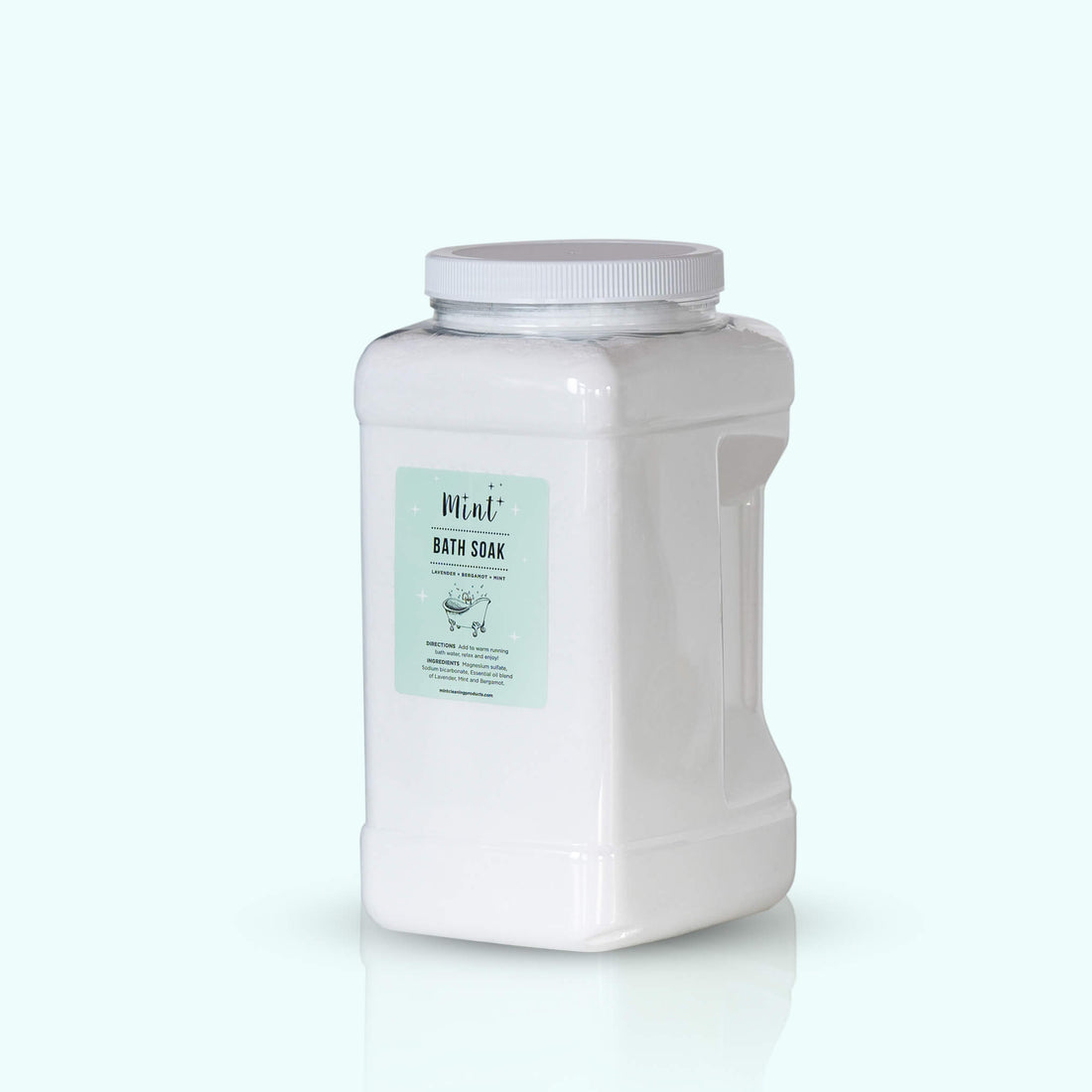 A large white plastic container with a handle, labeled "Mint+ Bath Soak." The label features a mint green background with minimalist design elements. The container is placed against a light mint background, reflecting a clean and calming aesthetic.