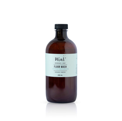 Brown bottle of floor wash with a label on a white background