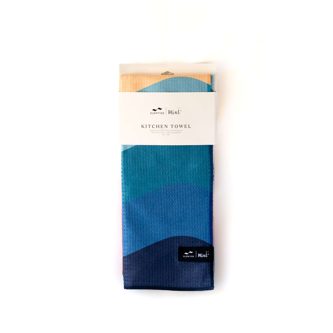 Blue and green kitchen towel in packaging on a white background