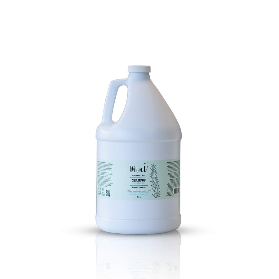 A 3.8-liter jug of Mint Cleaning Products' Rosemary Mint Shampoo. The white jug displays a mint-colored label with minimalist botanical designs and product information. Set against a white background with a slight reflective surface.