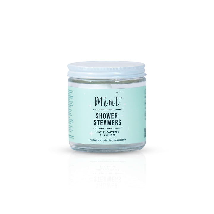 Mint Shower Steamers in a clear, reusable jar with a white background, labelled with 'Mint, Eucalyptus, Lavender' and eco-friendly features, emphasizing the minimalist, sustainable packaging.