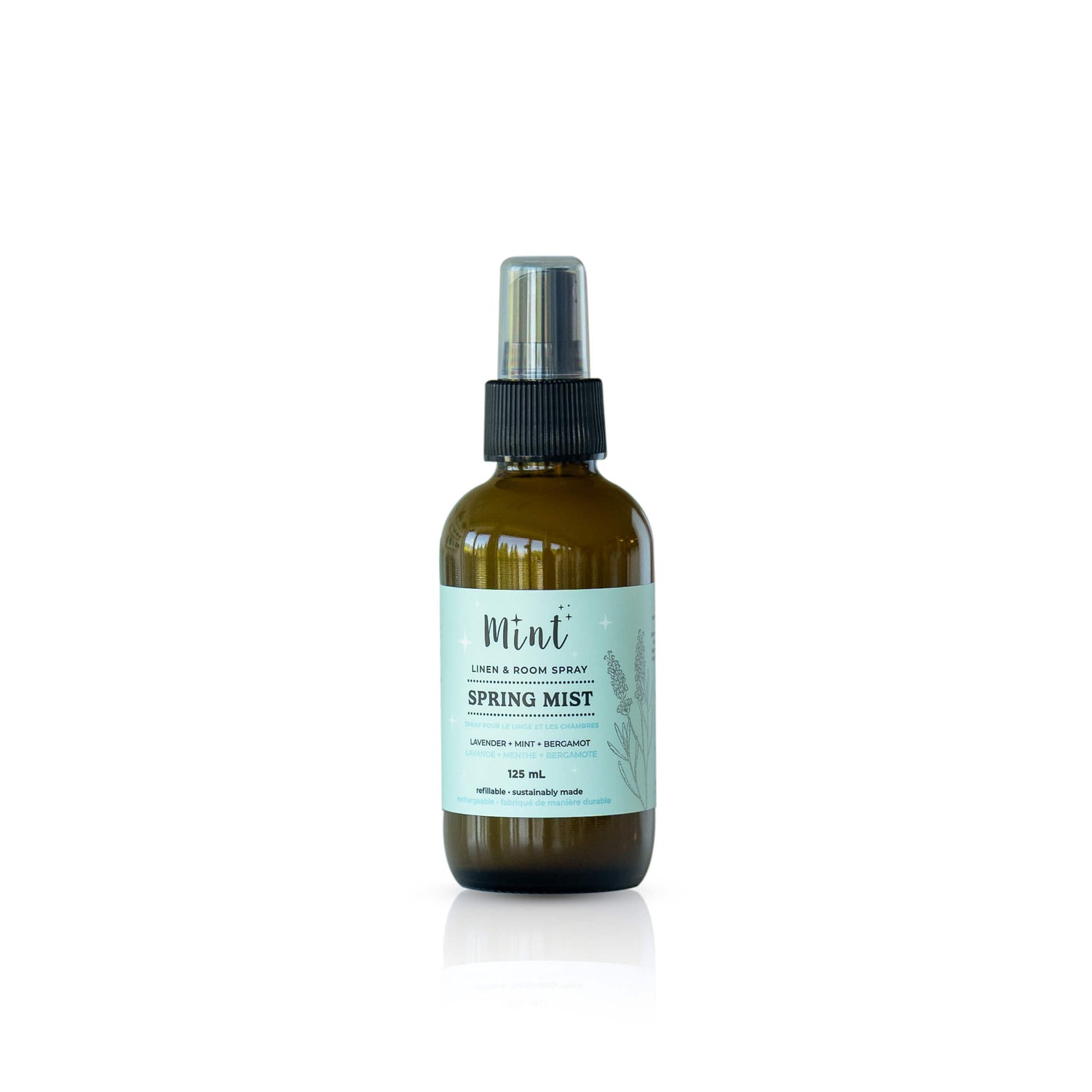 Mint Cleaning Products Spring Mist Linen + Room Spray in an amber glass bottle with a light blue label, featuring lavender, mint, and bergamot scents.