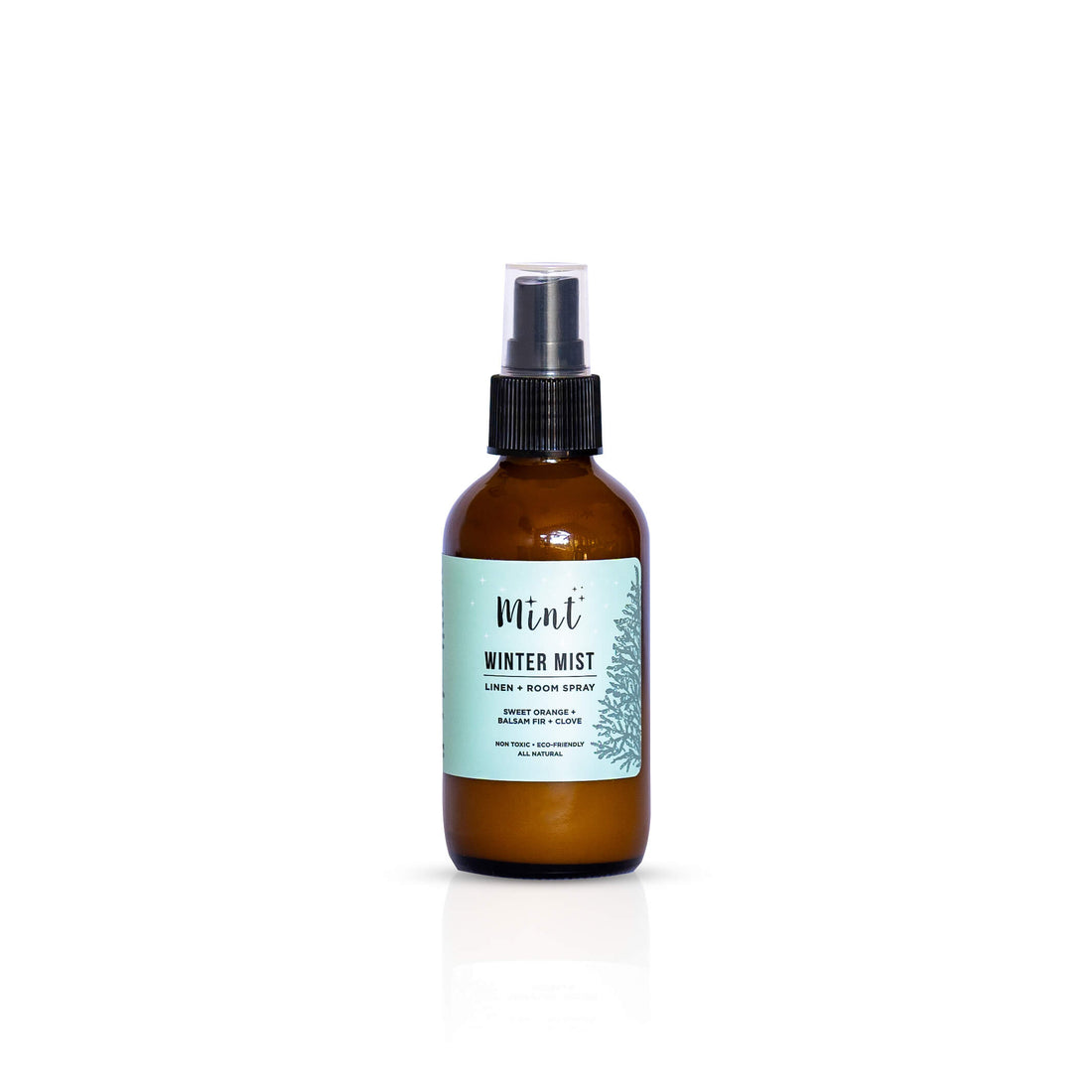 Mint Winter Mist Linen + Room Spray bottle isolated on a white background, highlighting the product label with ingredients like sweet orange, balsam fir, and clove.