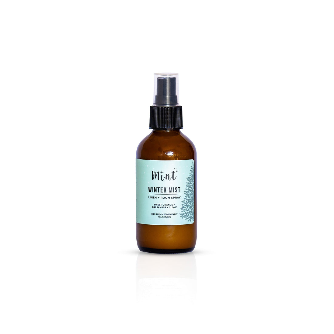 Mint Winter Mist Linen + Room Spray bottle isolated on a white background, highlighting the product label with ingredients like sweet orange, balsam fir, and clove.